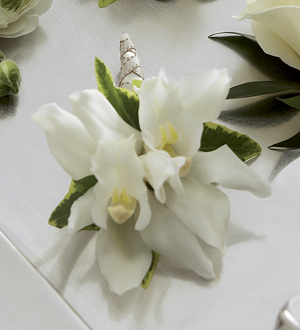 The FTD White Mini Cymbidium Boutonniere